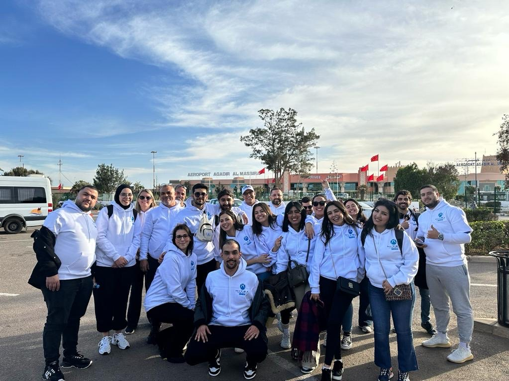 Hitek Logistic Morocco team members in white hoodies at Agadir Al Massira Airport, showcasing our diverse and unified workforce