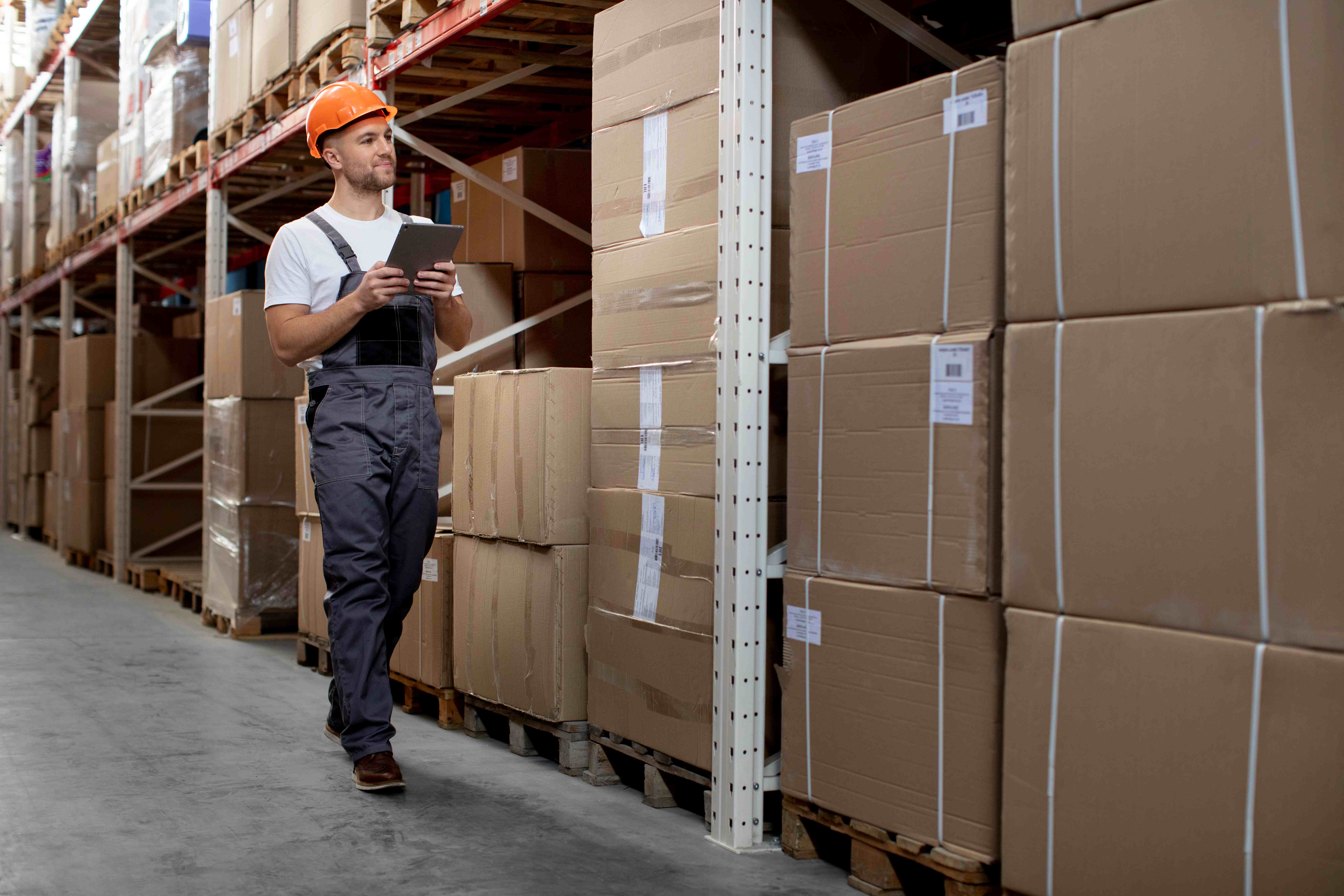 Warehouse worker managing inventory with a tablet